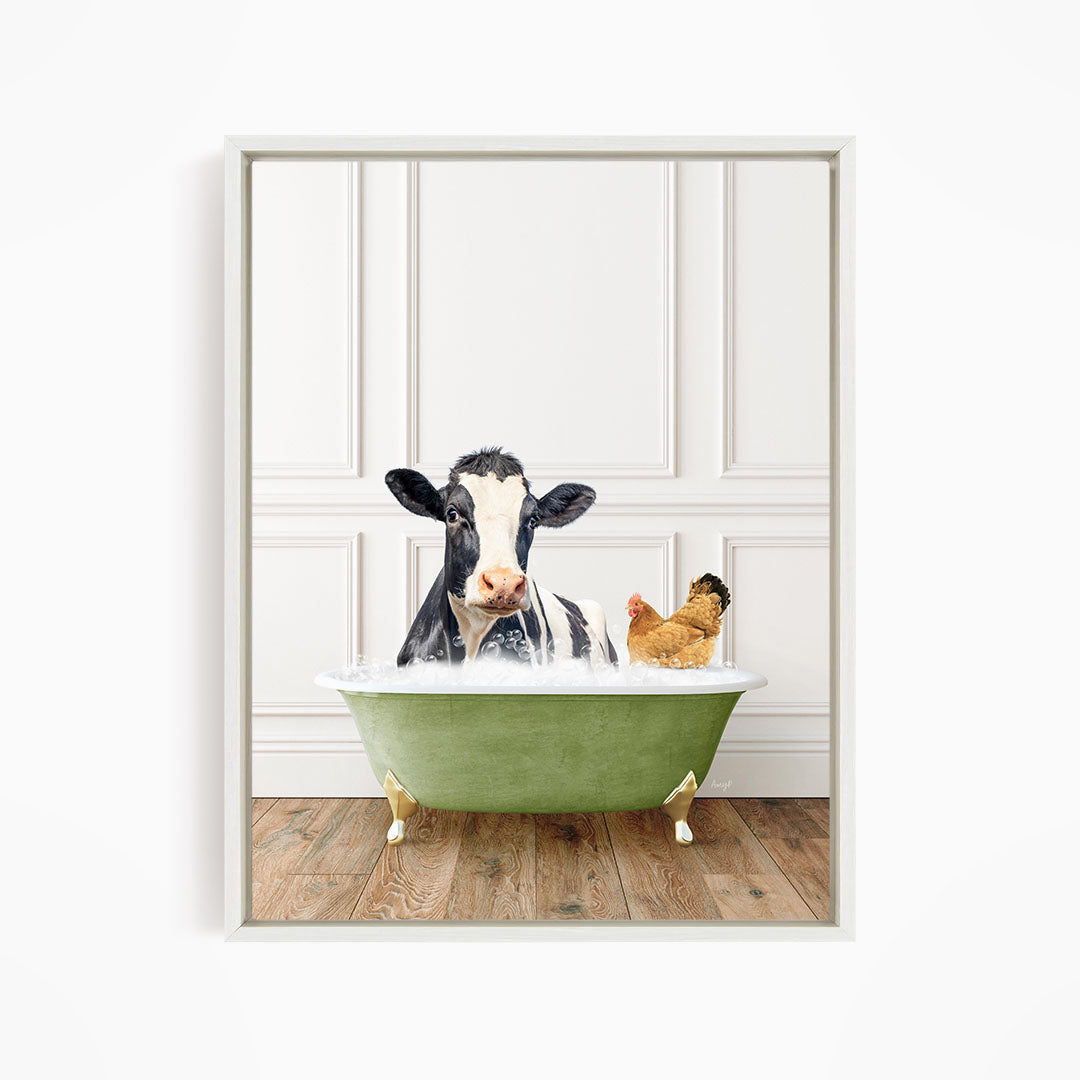A black and white cow is sitting in a green bathtub, with a chicken standing nearby, in a white-framed picture.