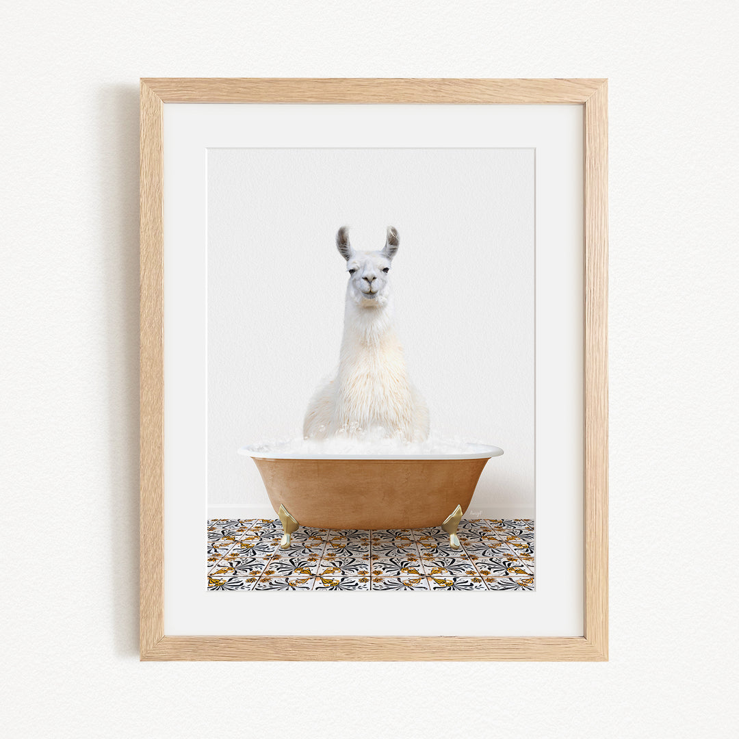 A white llama sitting in a brown bathtub filled with bubbles, with a patterned tile floor in the background.