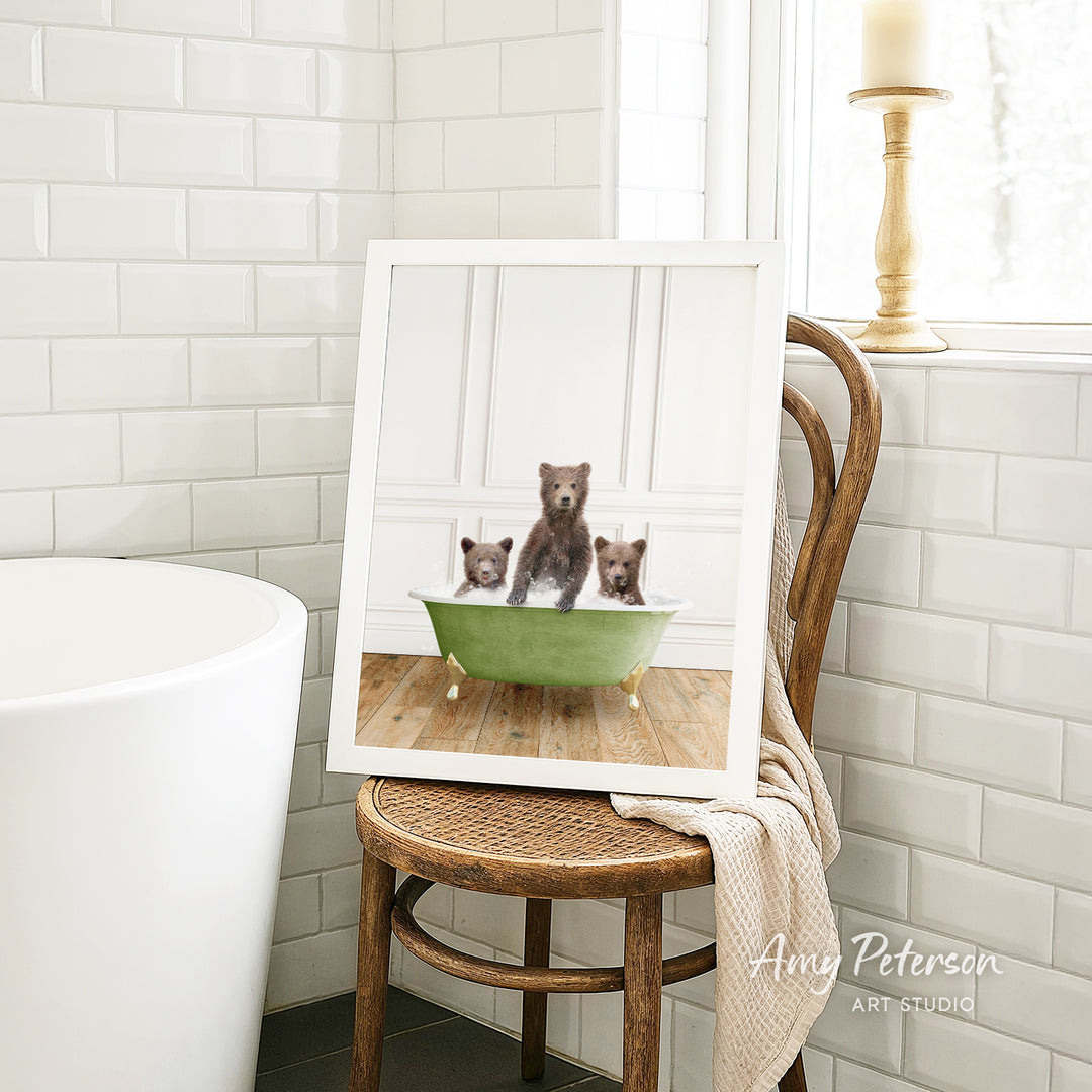 A framed image of three bears sitting in a green bathtub, with one bear sitting in the center and the other two bears sitting on either side.