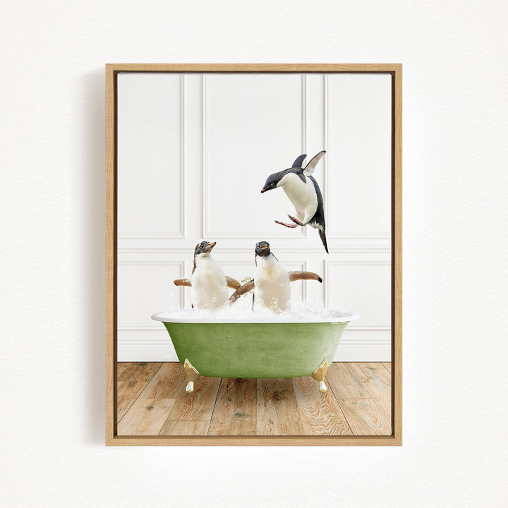 A framed image depicting two penguins sitting in a green bathtub, with one penguin jumping out of the tub.