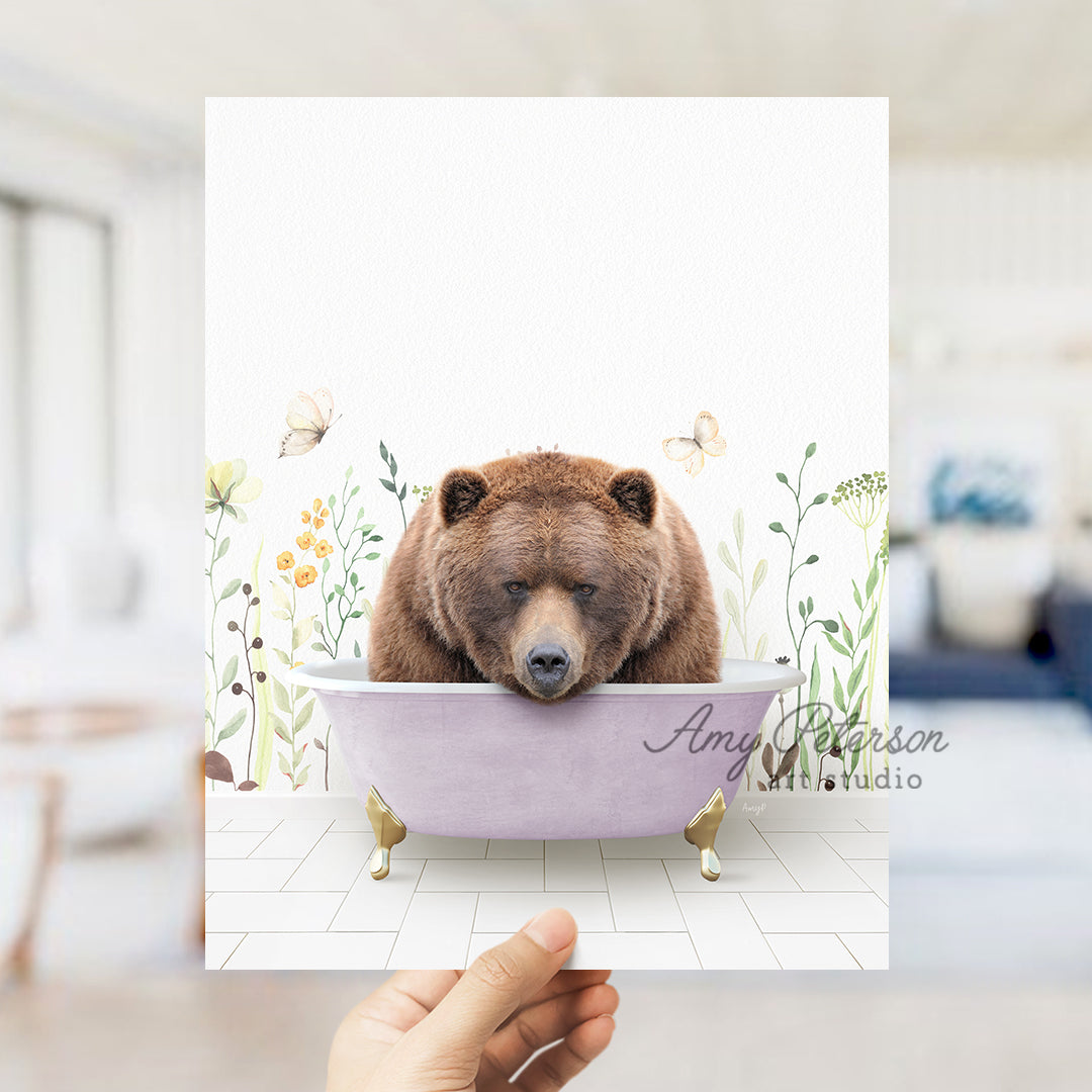 a hand holding a card with a bear in a bathtub