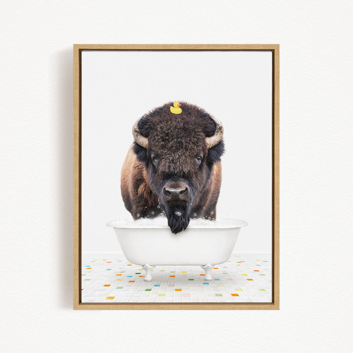 A buffalo with a yellow rubber duck perched on its head is standing in a white bathtub, surrounded by a colorful tiled floor.