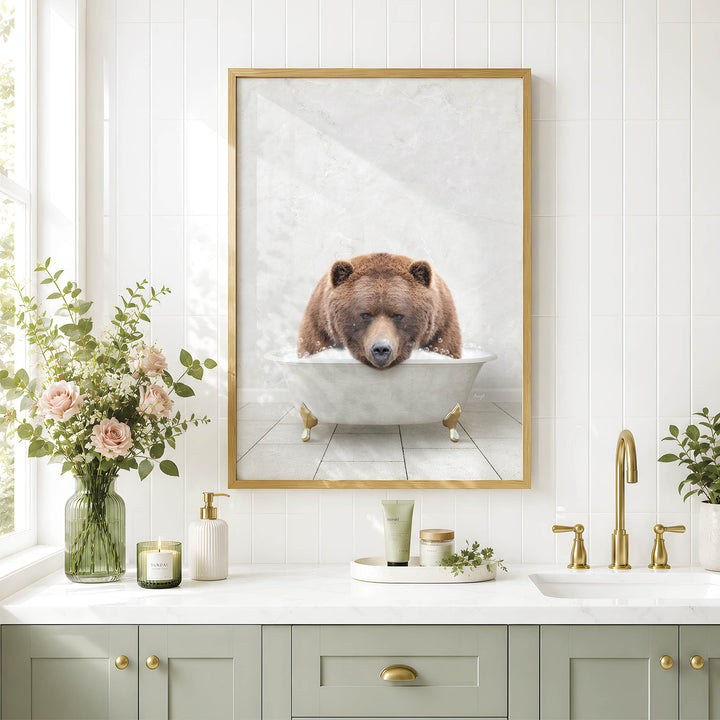 a bathroom with a framed picture of a bear sitting in a bathtub, surrounded by various bathroom accessories and decor.