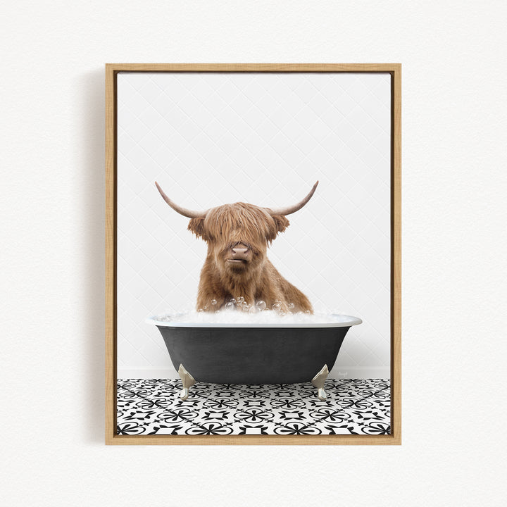 A Highland cow with shaggy brown hair is sitting in a black bathtub filled with water, creating a whimsical and playful scene.