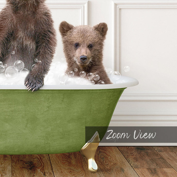 A young bear cub sitting in a green bathtub filled with bubbles, with a white wall in the background.