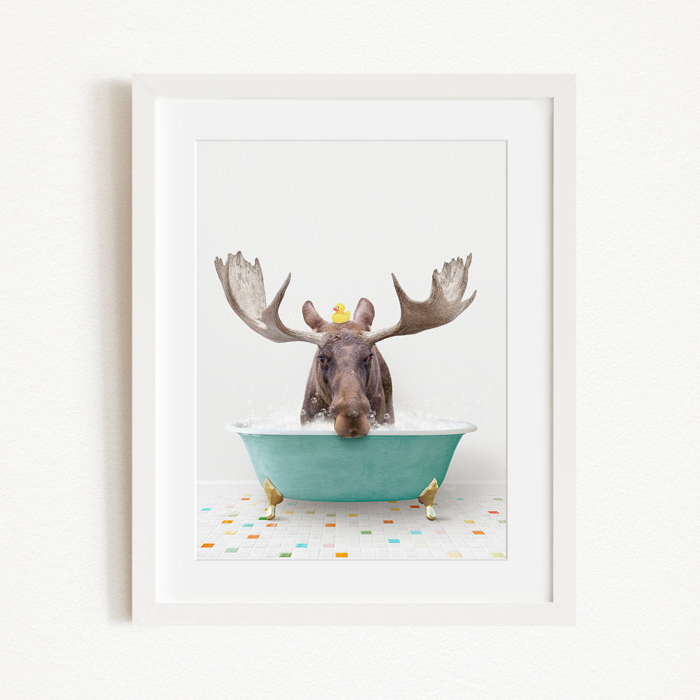 A moose with large antlers is sitting in a green bathtub, surrounded by small yellow chicks.