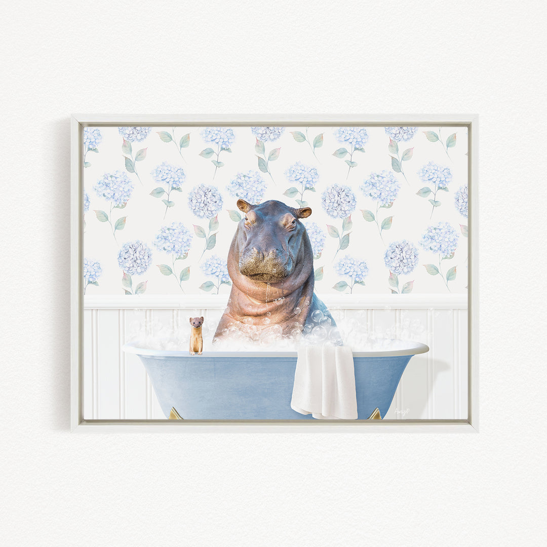 A hippopotamus sitting in a blue bathtub, surrounded by a floral patterned wall and a small cat.