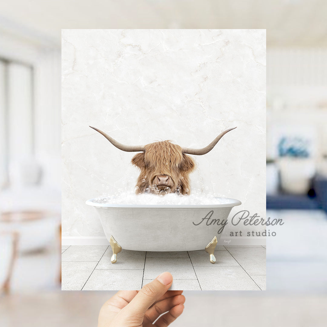 a hand holding up a photo of a bull in a bathtub