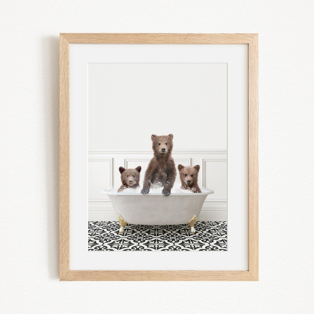 A framed image depicting three bears sitting in a bathtub, with one bear sitting in the center and the other two bears sitting on either side.