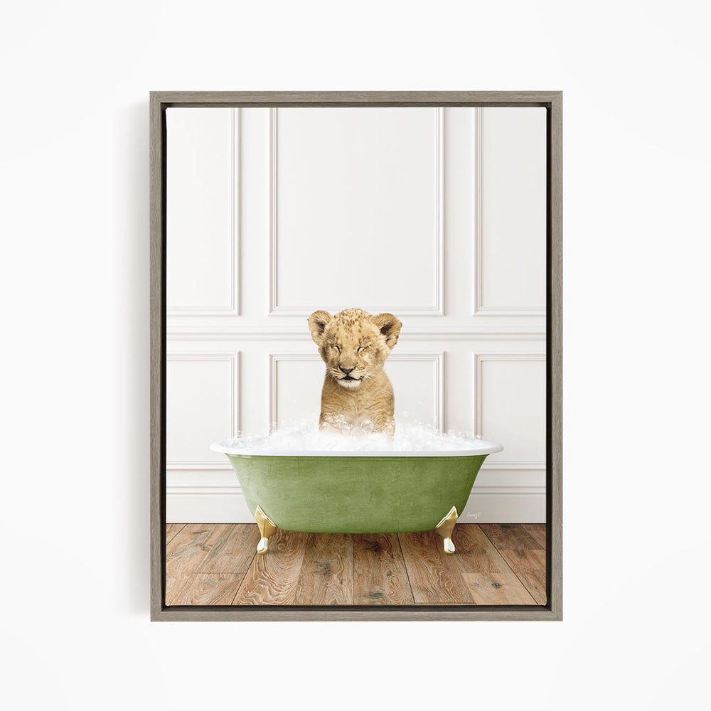 A young lion cub sitting in a green bathtub filled with water, with its eyes closed and appearing to be enjoying the bath.
