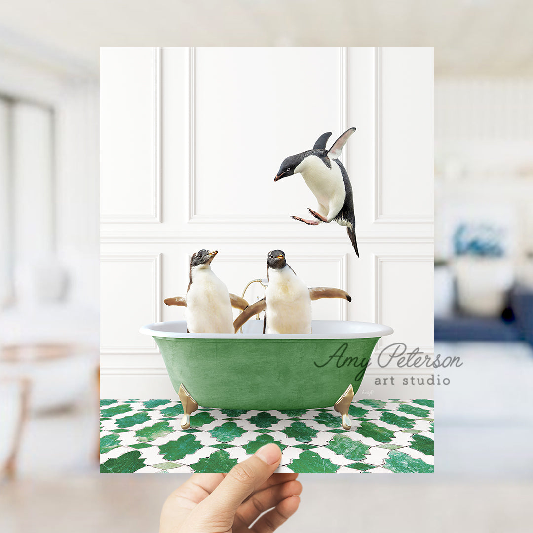 a hand holding a card with three penguins in a bathtub