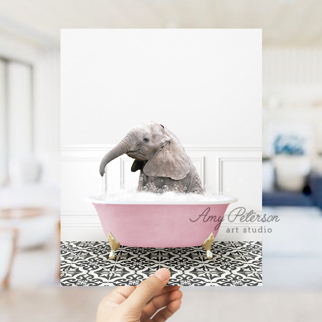 a hand holding a card with a picture of a baby elephant in a bathtub