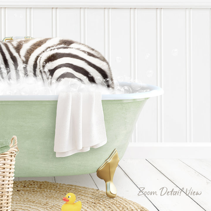 A zebra lying in a green bathtub filled with bubbles, surrounded by a yellow rubber duck and a towel.