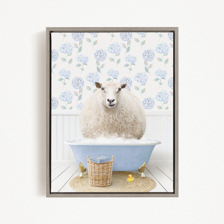 A fluffy white sheep sits in a blue bathtub filled with bubbles, surrounded by a wicker basket and a yellow rubber duck.