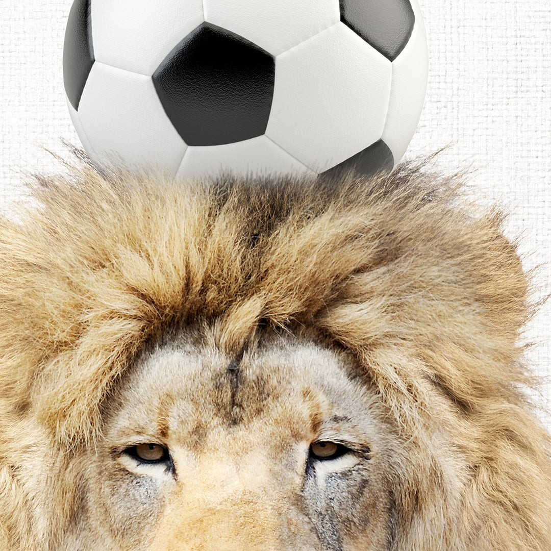 a lion with a soccer ball on its head