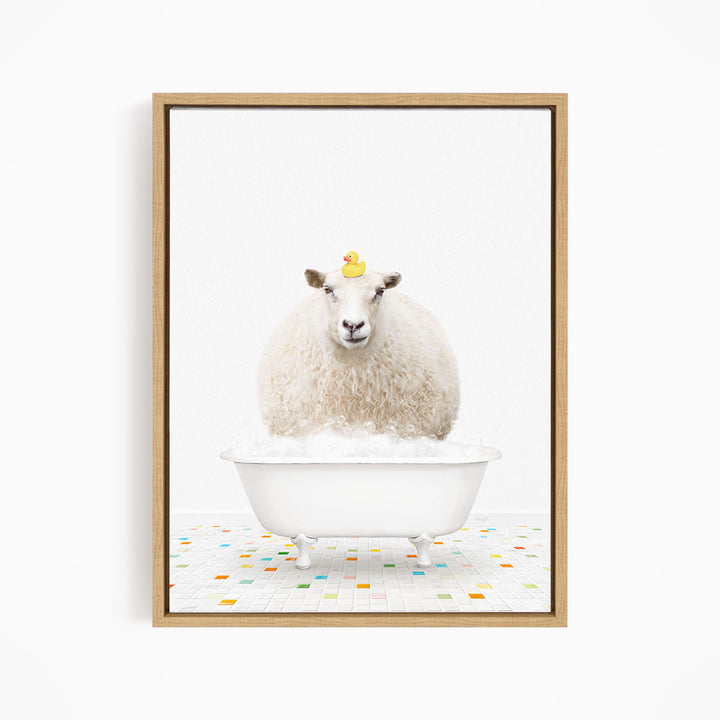 A fluffy white sheep sits in a white bathtub filled with bubbles, with a yellow rubber duck perched on its head.
