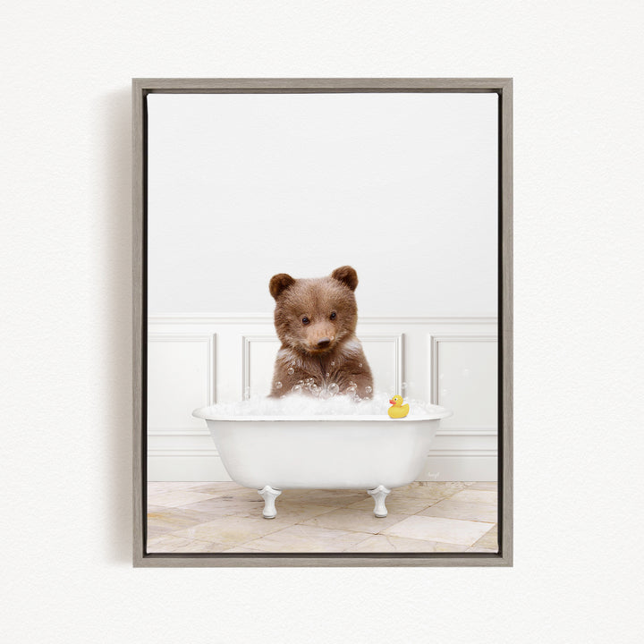 A brown bear sitting in a white bathtub filled with bubbles, with a rubber duck floating on the water.