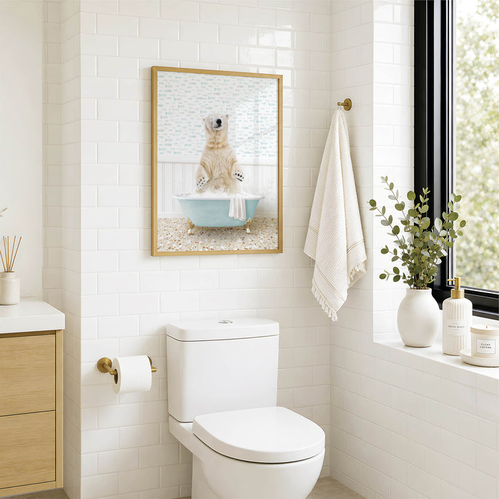a bathroom with a white toilet, a framed picture of a polar bear sitting in a bathtub, and a window with a plant on the sill.