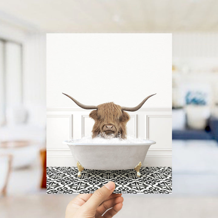 A Highland cow with large horns is sitting in a white bathtub filled with water, creating a whimsical and unexpected scene.
