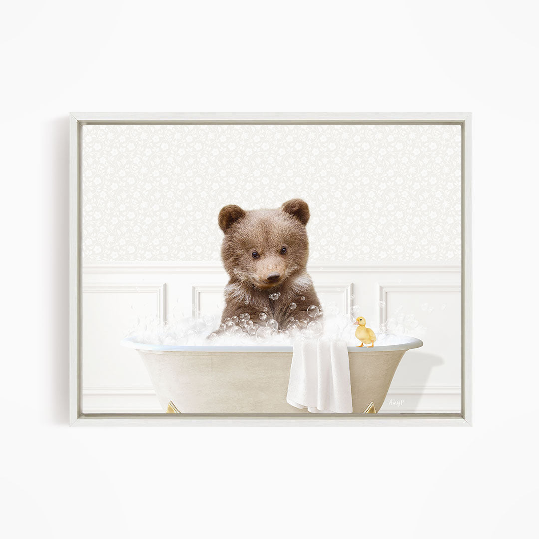 A brown bear sitting in a bathtub filled with bubbles, with a yellow duck nearby.