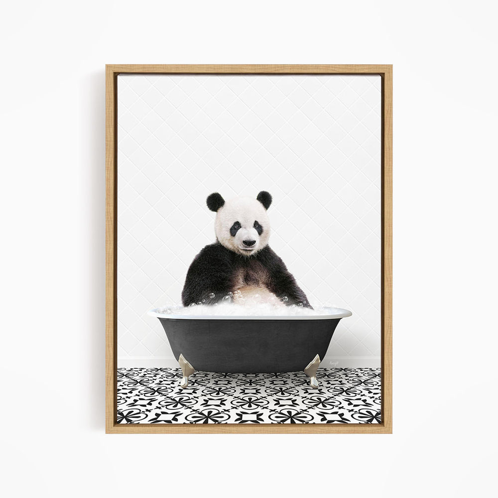 A panda bear sitting in a bathtub filled with bubbles, surrounded by a black and white patterned floor.