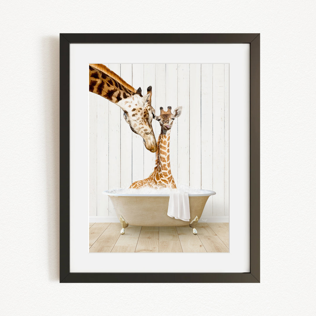 A mother giraffe and her baby giraffe are sitting together in a bathtub, with the mother gently licking her baby.