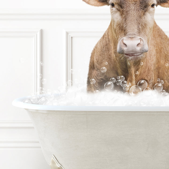 a brown cow sitting in a bathtub filled with bubbles