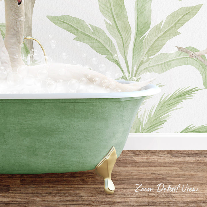 A green clawfoot bathtub filled with bubbles, with a person relaxing in it. The bathtub is placed on a wooden floor, and there is a wall with a tropical plant design in the background.