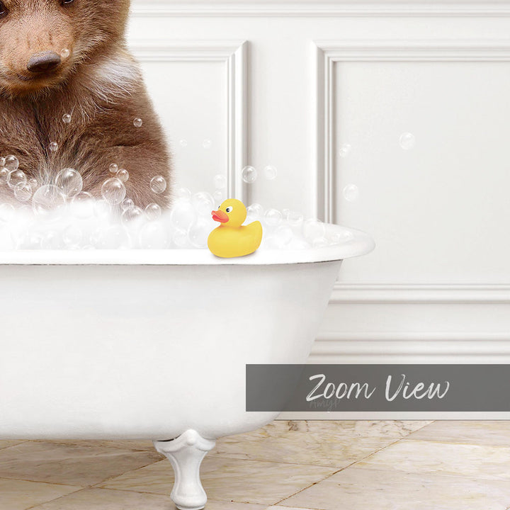 A brown bear is sitting in a white bathtub filled with bubbles, with a yellow rubber duck floating on the water.