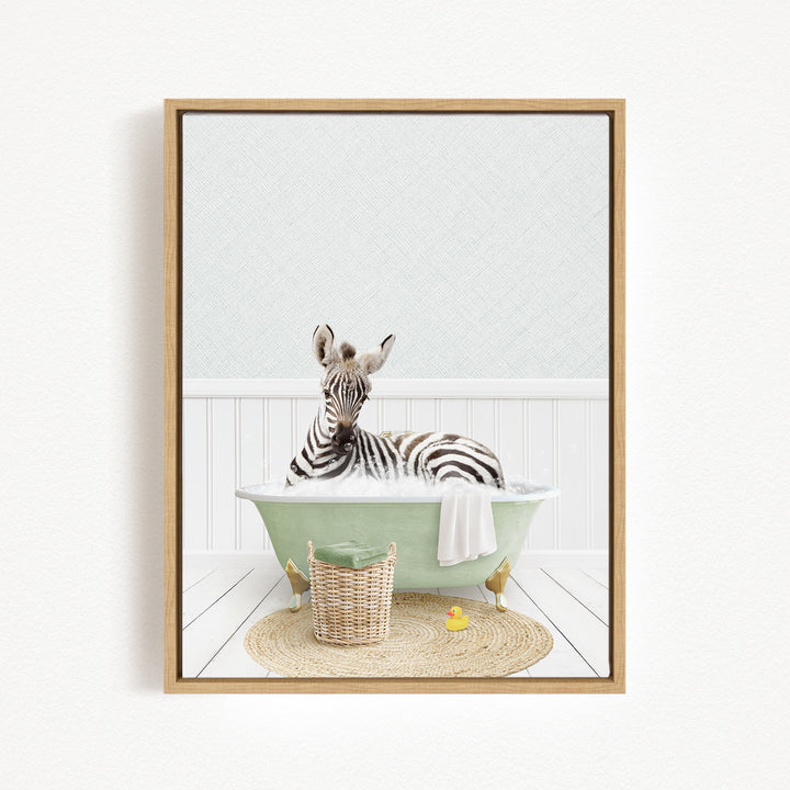 A zebra is sitting in a green bathtub filled with water, surrounded by a basket and a rubber duck.