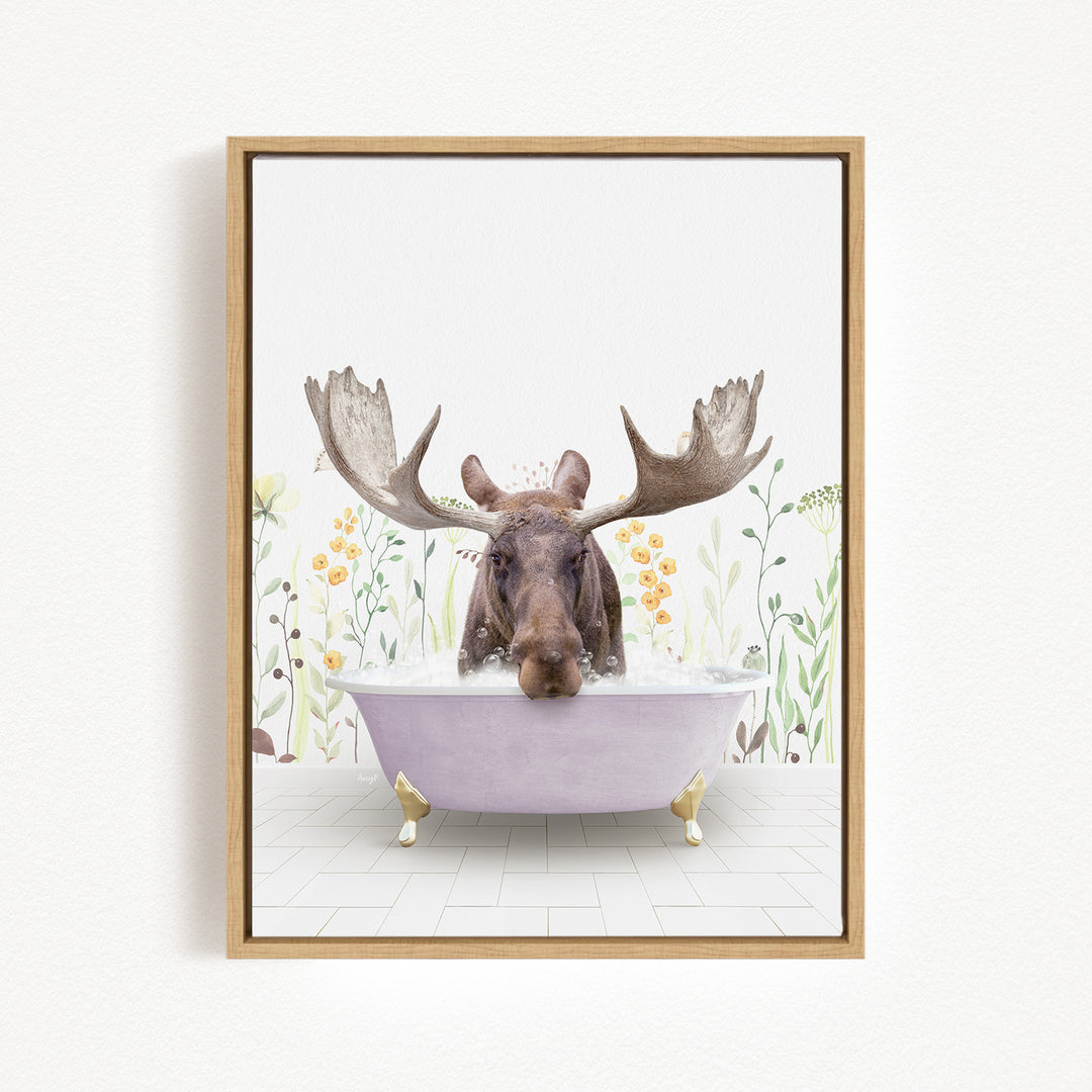 A moose with large antlers is sitting in a bathtub filled with water, surrounded by flowers and plants.