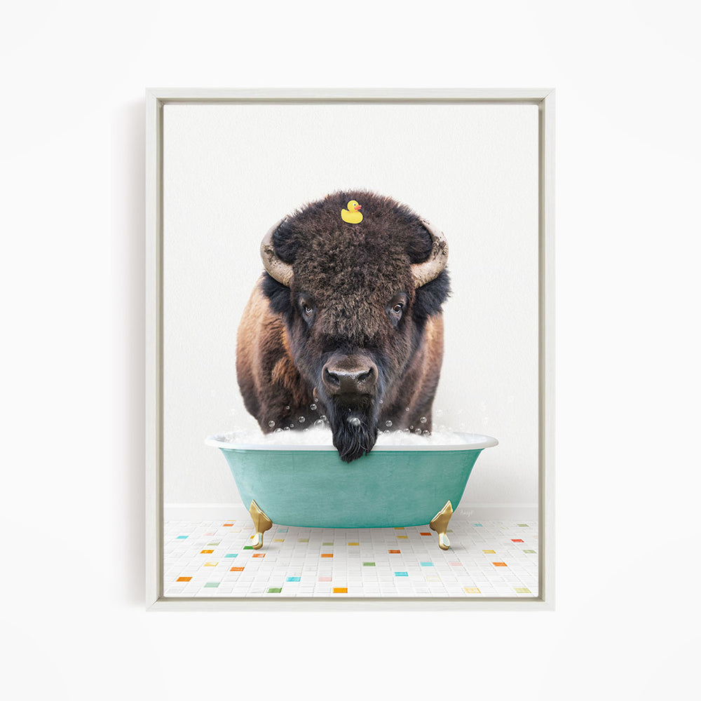 A buffalo with a yellow rubber duck sitting in a green bathtub.