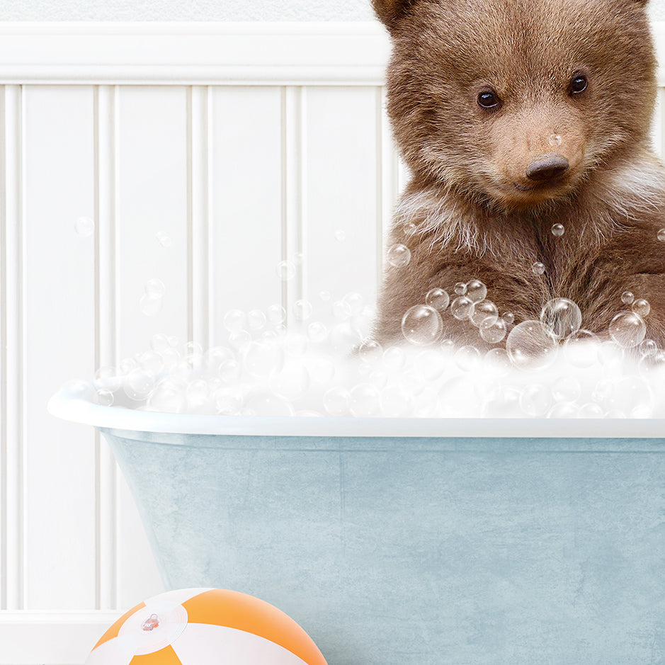 a brown bear sitting in a bath tub filled with bubbles