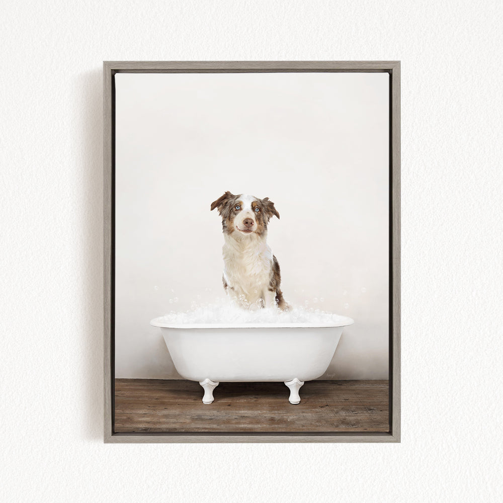 A dog sitting in a white bathtub filled with bubbles, looking directly at the camera.