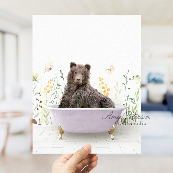 a hand holding up a card with a bear in a bathtub