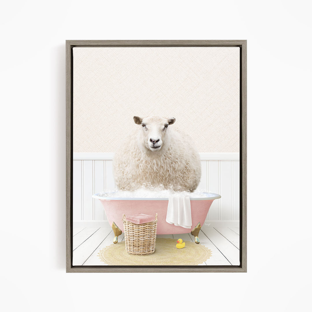A fluffy white sheep sits in a pink bathtub filled with bubbles, surrounded by a yellow rubber duck and a wicker basket.
