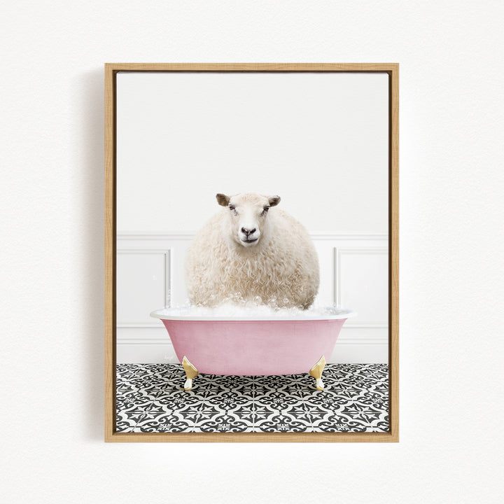 A fluffy white sheep sits in a pink bathtub filled with bubbles, surrounded by a black and white patterned floor.