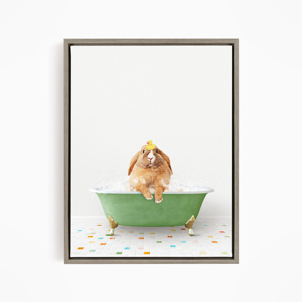 A brown rabbit sitting in a green bathtub filled with bubbles, wearing a yellow hat.