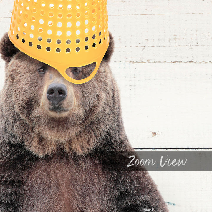 A close-up of a bear wearing a yellow plastic bucket hat, with the text "Zoom View" below the image.