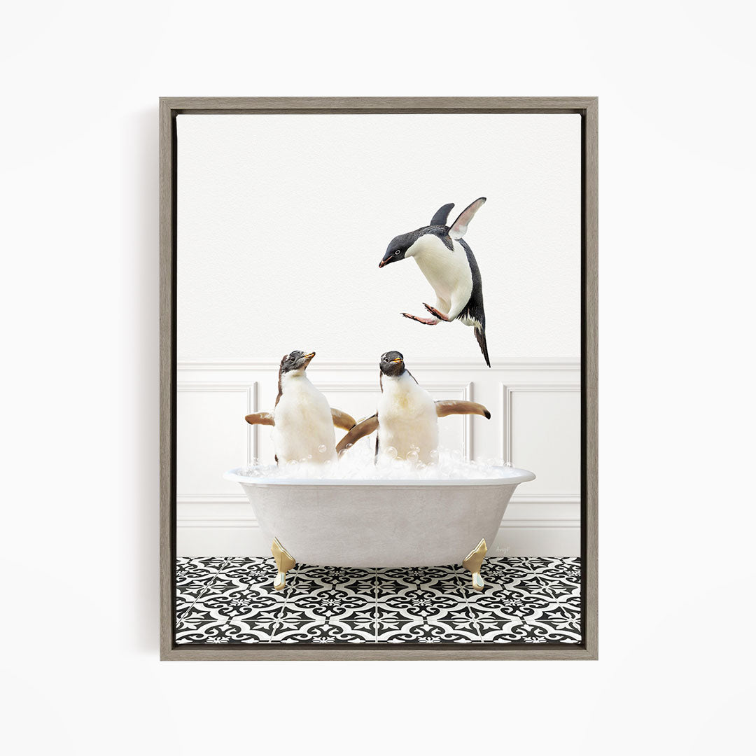 A framed image depicting two penguins sitting in a bathtub, with one penguin jumping out of the tub.