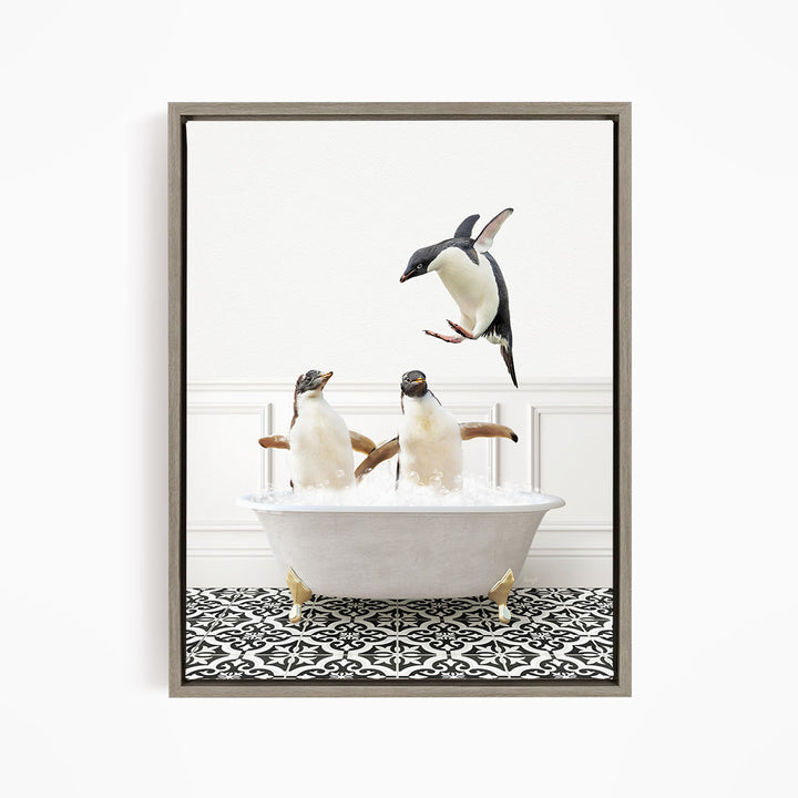 A framed image depicting two penguins sitting in a bathtub, with one penguin jumping out of the tub.