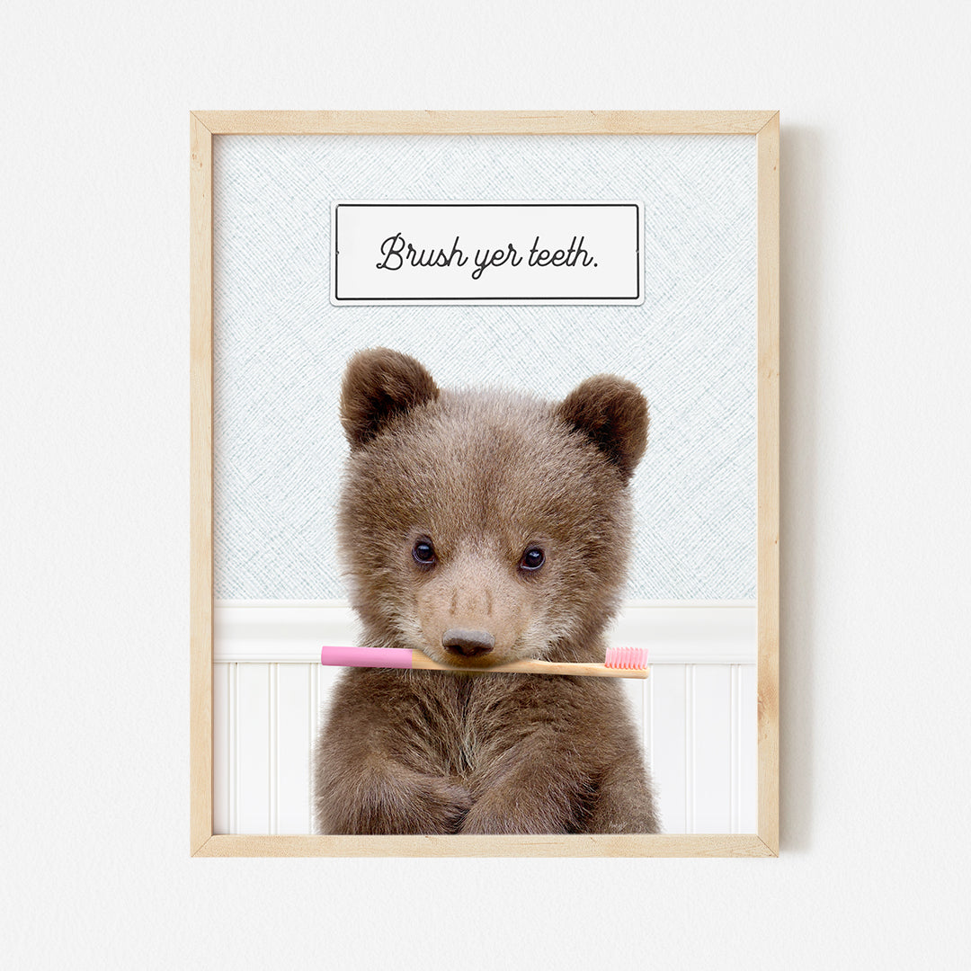 a picture of a brown bear holding a toothbrush