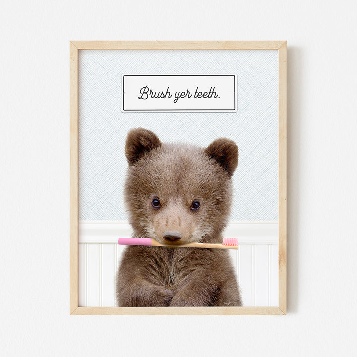 a picture of a brown bear holding a toothbrush