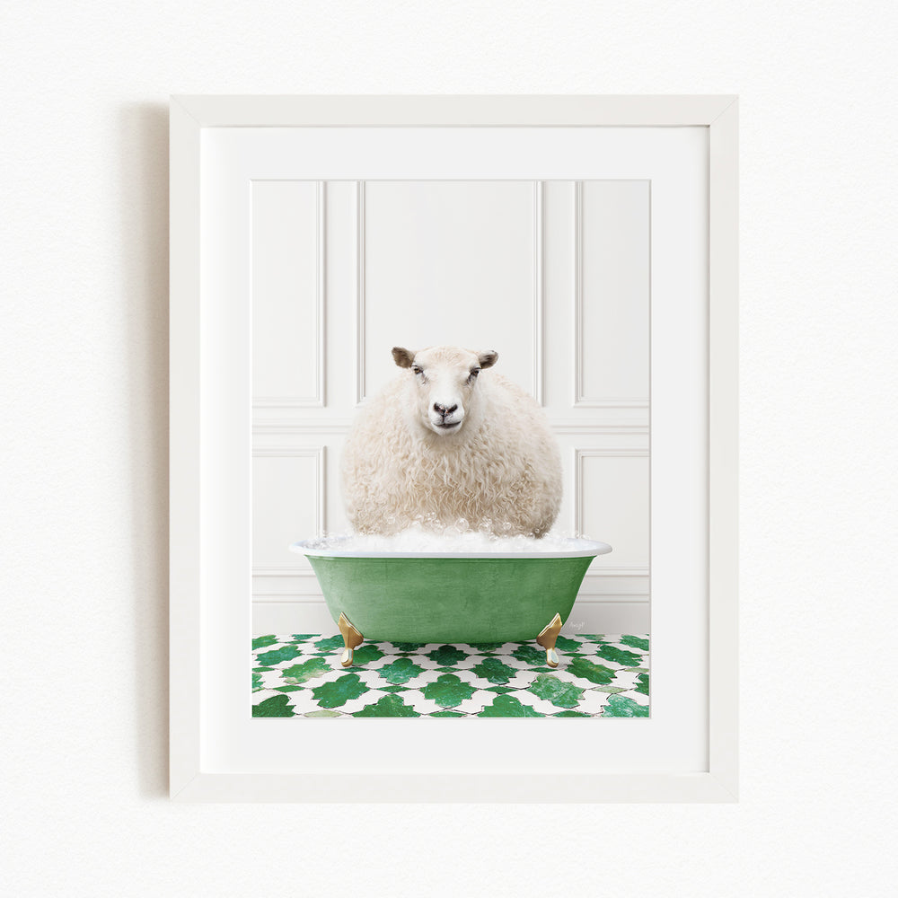 A fluffy white sheep sits in a green bathtub filled with bubbles, surrounded by a green and white patterned rug.