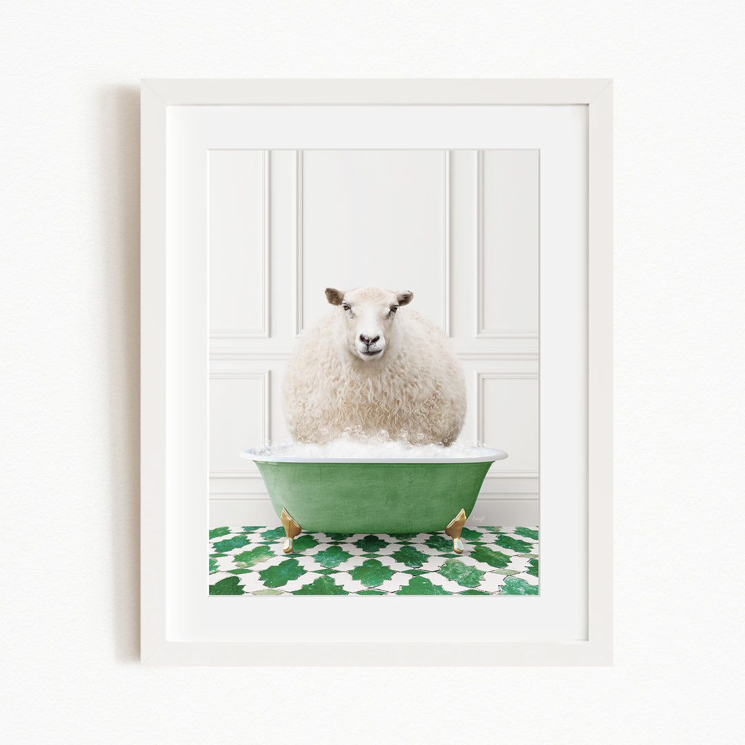 A fluffy white sheep sits in a green bathtub filled with bubbles, surrounded by a green and white patterned rug.