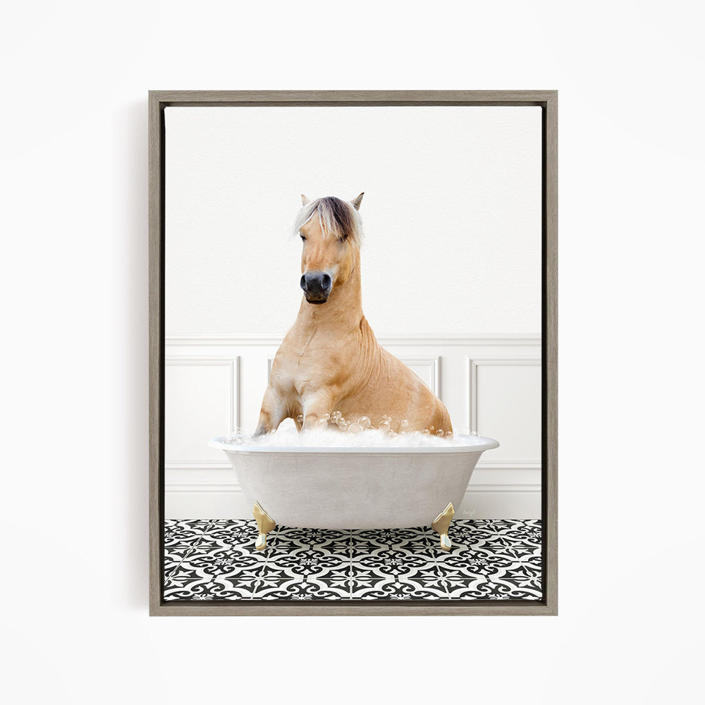 A light brown horse is sitting in a white bathtub filled with water, surrounded by a black and white patterned floor.