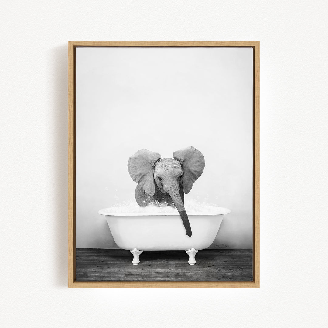 A baby elephant sitting in a white bathtub filled with water, creating a playful and whimsical scene.