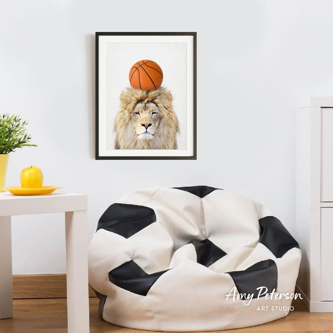 a framed picture of a lion with a basketball on its head, hanging on a wall in a room with a white table and a black and white bean bag chair.