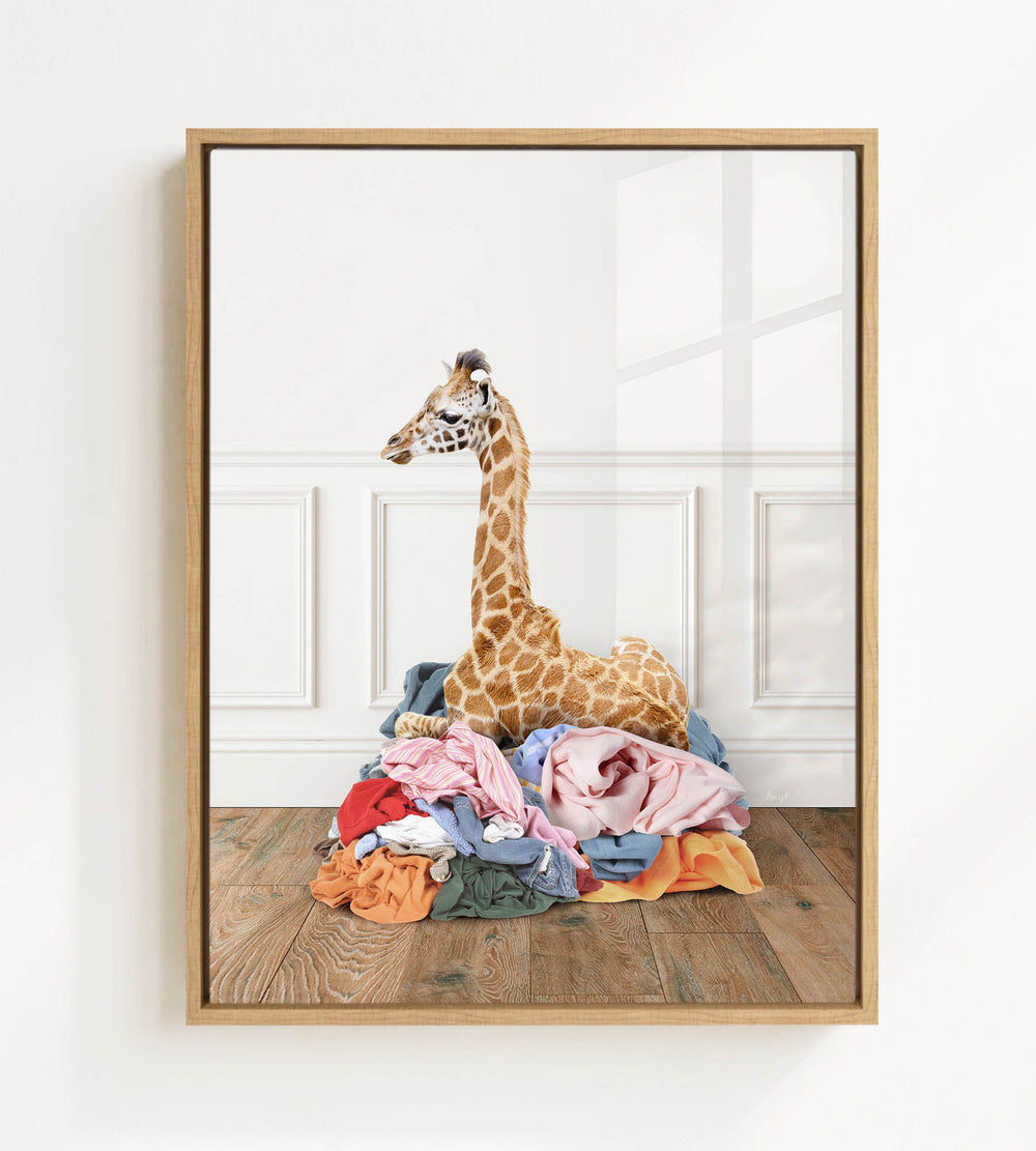 A giraffe standing on a pile of clothes in a room.