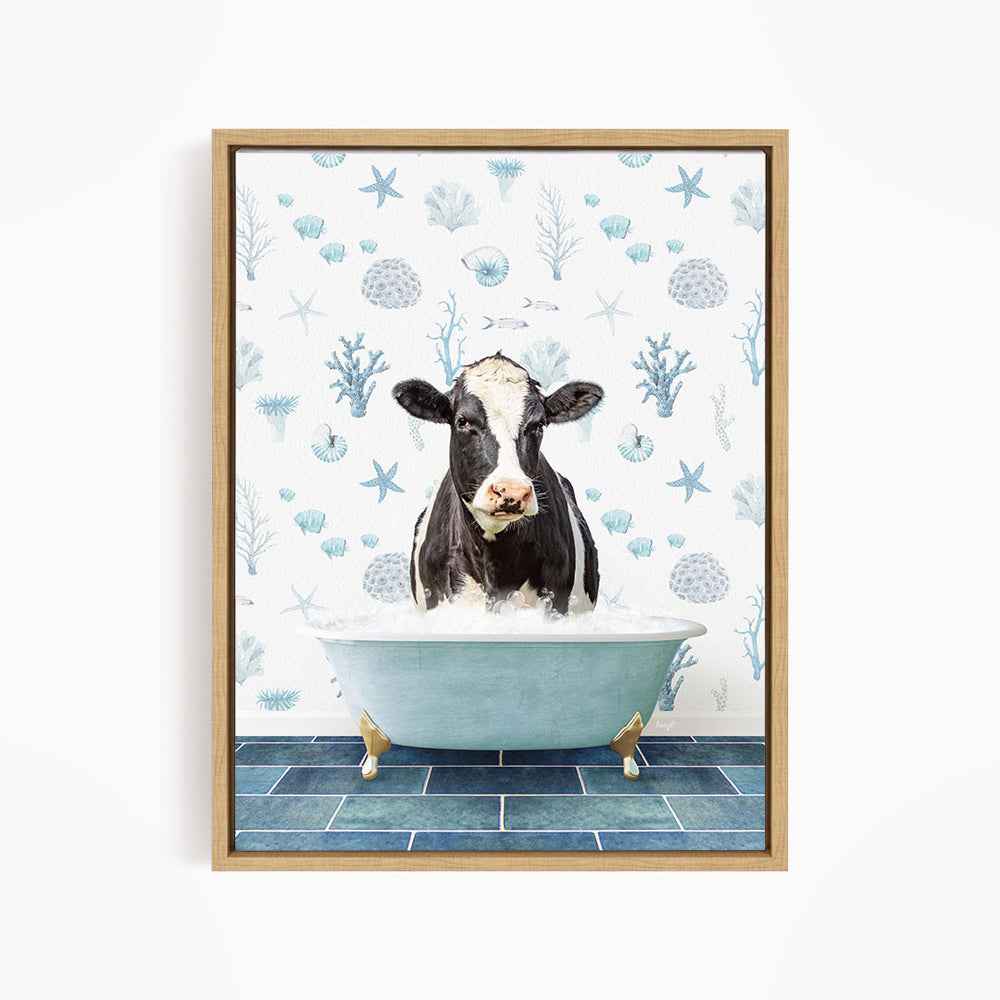 A black and white cow is sitting in a blue bathtub filled with water, surrounded by a pattern of seashells and starfish.